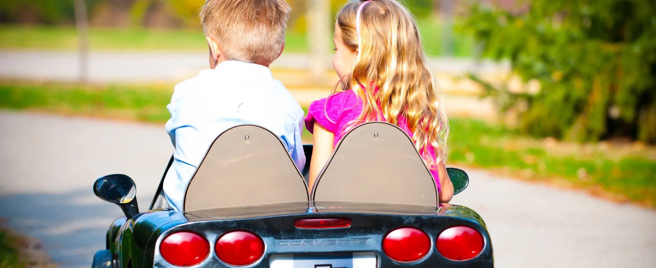 Children driving toy car